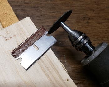using Dremel with cutting wheel to enlarge
    edge notches